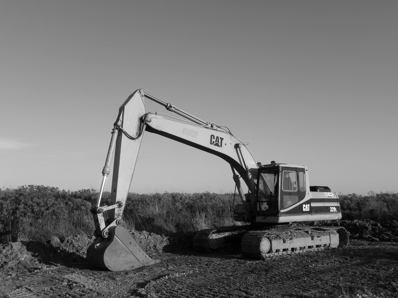 Crafting Captivating Headlines: Your awesome post title goes here Monochrome image of an excavator at a construction site, ideal for industry themes.
