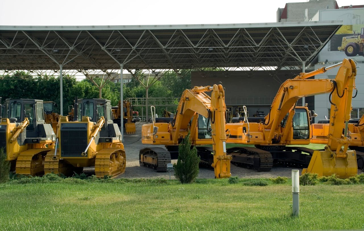 service-01 Heavy-duty construction machinery displayed outdoors, include excavators and bulldozers.